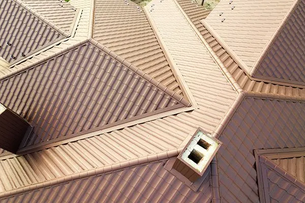 Brown steel roof with hips, valleys and a chimney