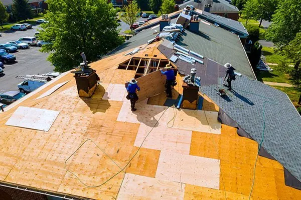 Crew stripping an old roof back to the decking